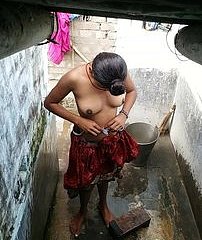 Indian woman in slay rub elbows with shower